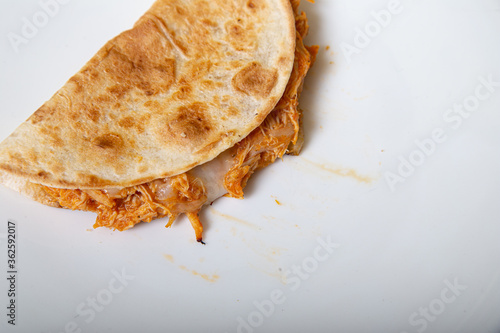 Chicken and tinga quesadilla: Mexican quesadilla stuffed with chicken and grated minced cheese isolated on white background