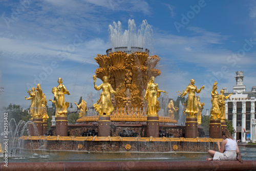 View of fountain Friendship of Peoples in VDNH park in Moscow on a blue sky background at sunny summer day. Architecture of VDNH park
