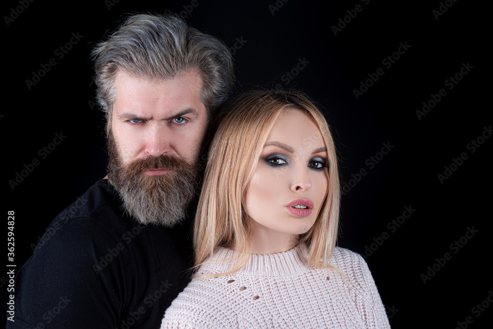 Sensual portrait of young stylish fashion couple posing on black background. Sensual portrait of young stylish fashion couple posing on black background.