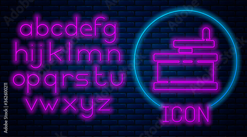 Glowing neon Manual grinder icon isolated on brick wall background. Neon light alphabet. Vector Illustration.