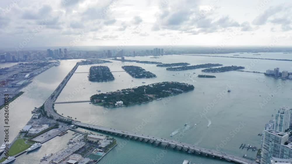 Slow motion top view of private residential Islands in Miami bay area. Miami downtown on a background on cloudy day. Beautiful cityscape. 4K aerial stock video for tourism business. Florida, USA Slow motion top view of private residential Islands in Miami bay area. Miami downtown on a background on cloudy day. Beautiful cityscape. 4K aerial stock video for tourism business. Florida, USA