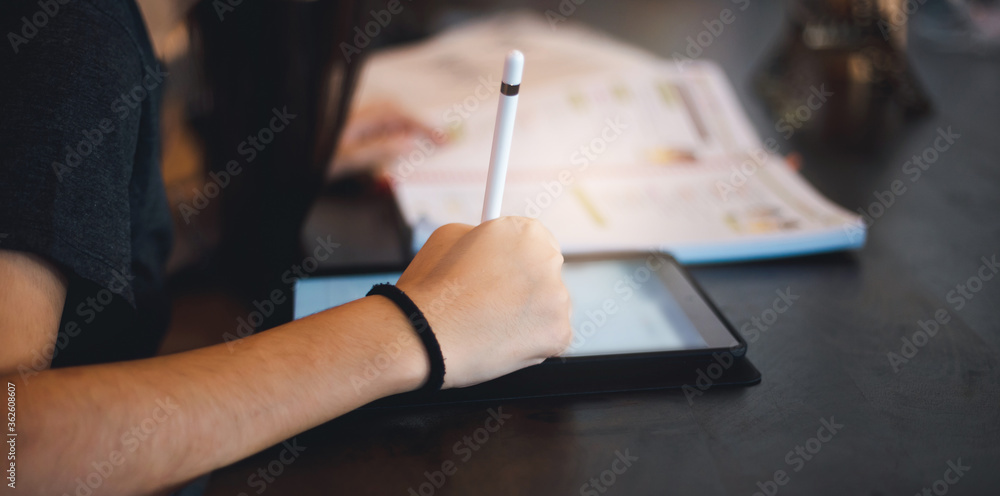 Close-up of hand young asian woman using digital tablet working online. concept work at home Close-up of hand young asian woman using digital tablet working online. concept work at home