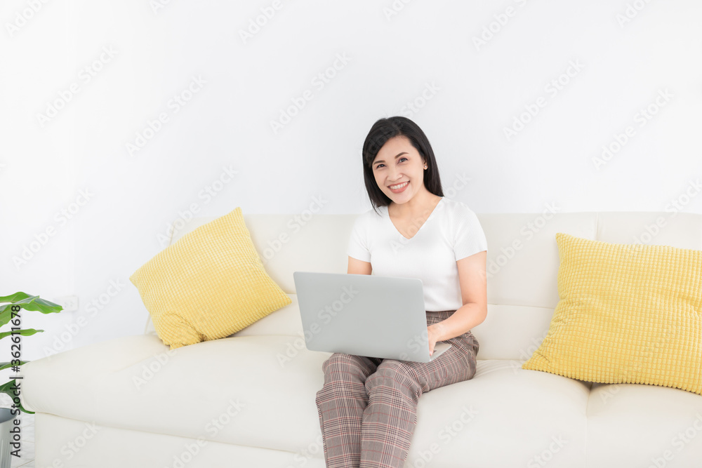 attractive asian female connect internet and social network with laptop, she feeling happy and smile in relax time, work from home attractive asian female connect internet and social network with laptop, she feeling happy and smile in relax time, work from home