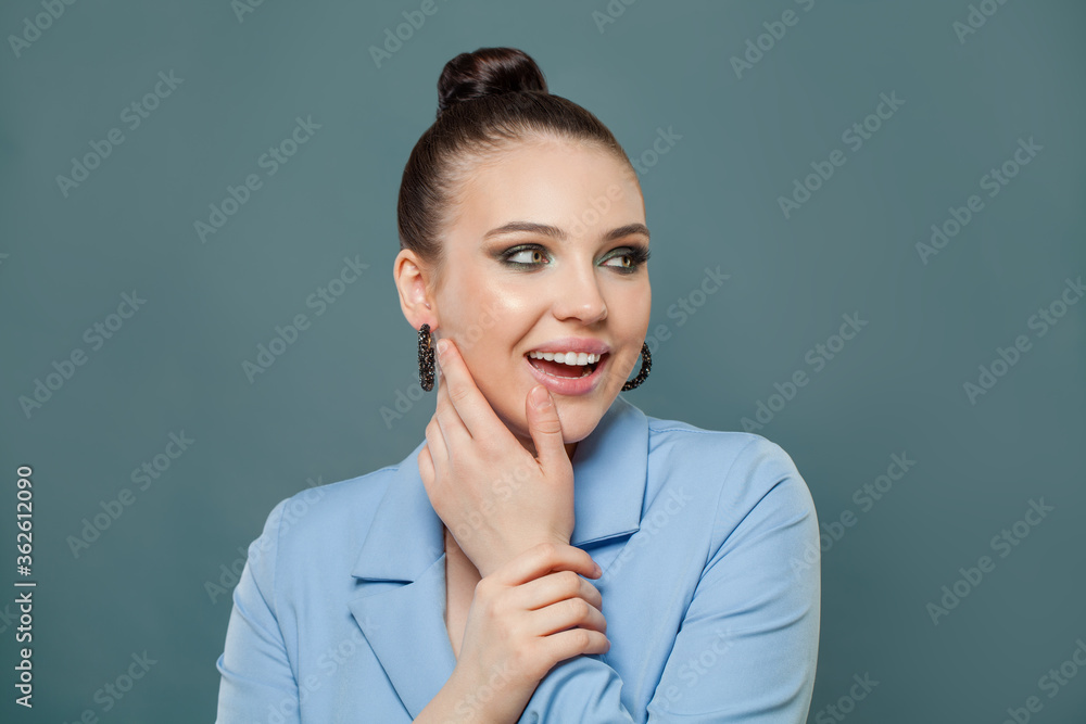 Nice woman smiling on blue background fashion portrait Nice woman smiling on blue background fashion portrait