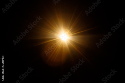 Easy to add lens flare effects for overlay designs or screen blending mode to make high-quality images. Abstract sun burst, digital flare, iridescent glare over black background. photo