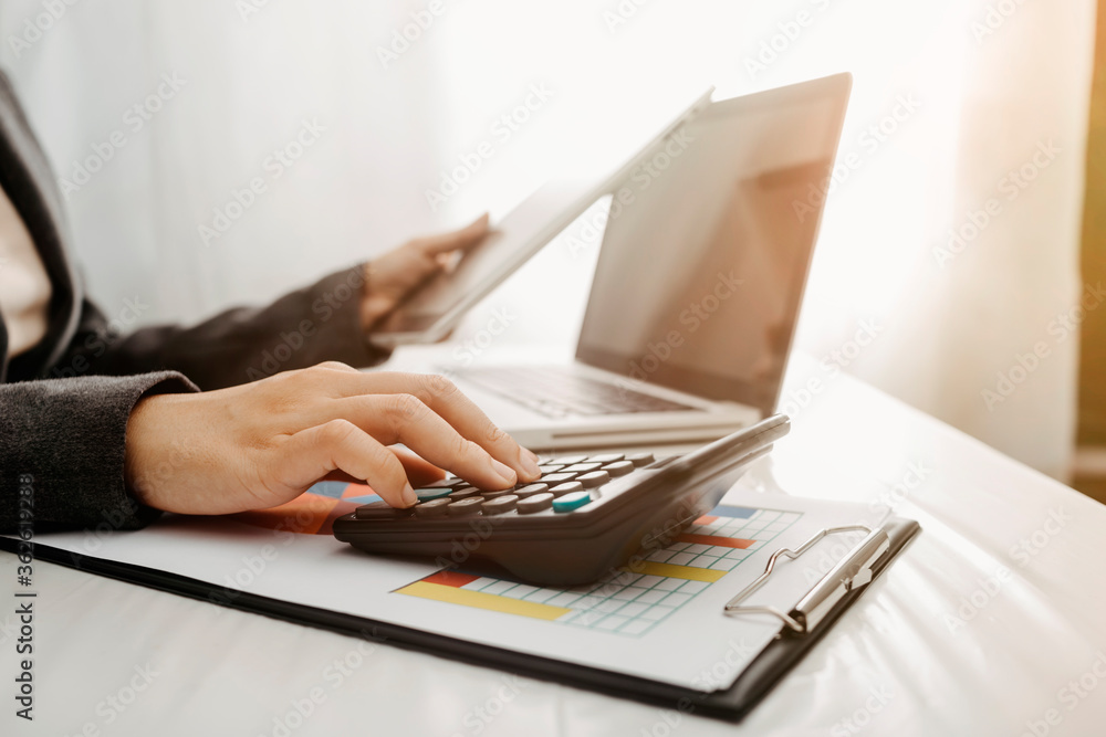 Healthcare costs and fees concept.Hand of smart doctor used a calculator for medical costs in modern hospital