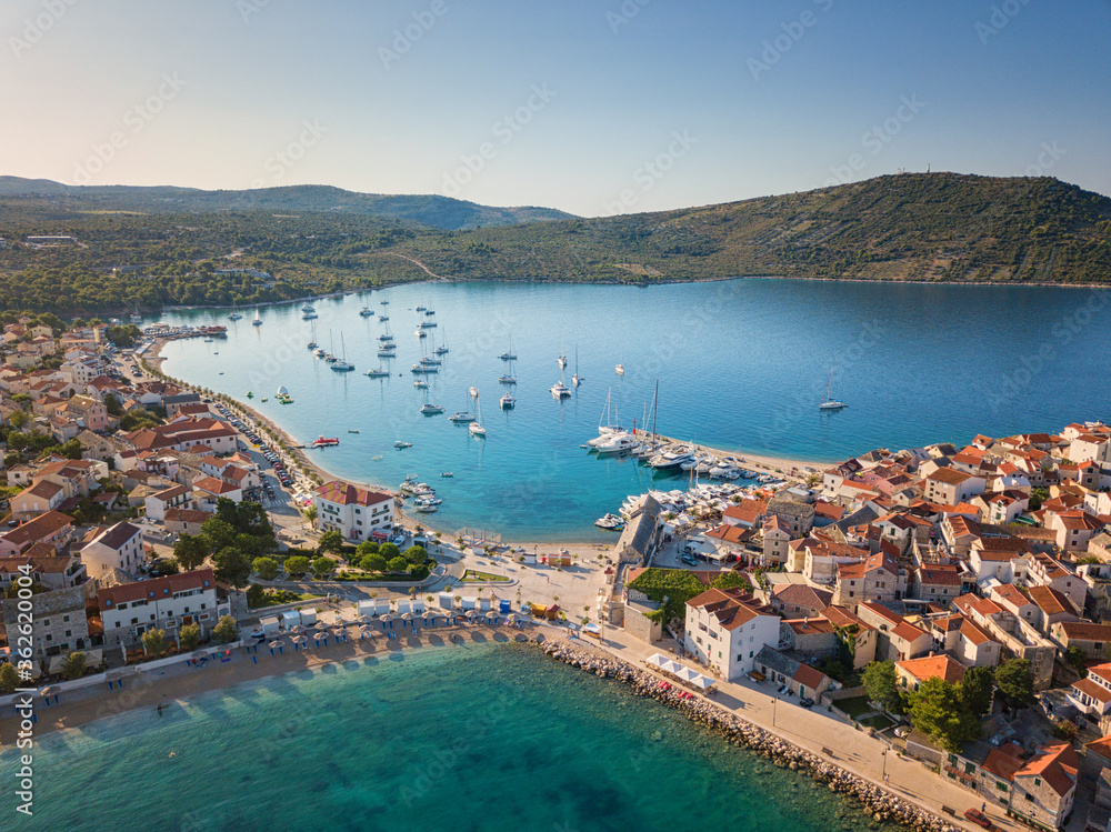 Aerial view of Primosten old town on the islet, amazing sunny landscape, Dalmatia, Croatia. Famous tourist resort on Adriatic sea coast, outdoor travel background