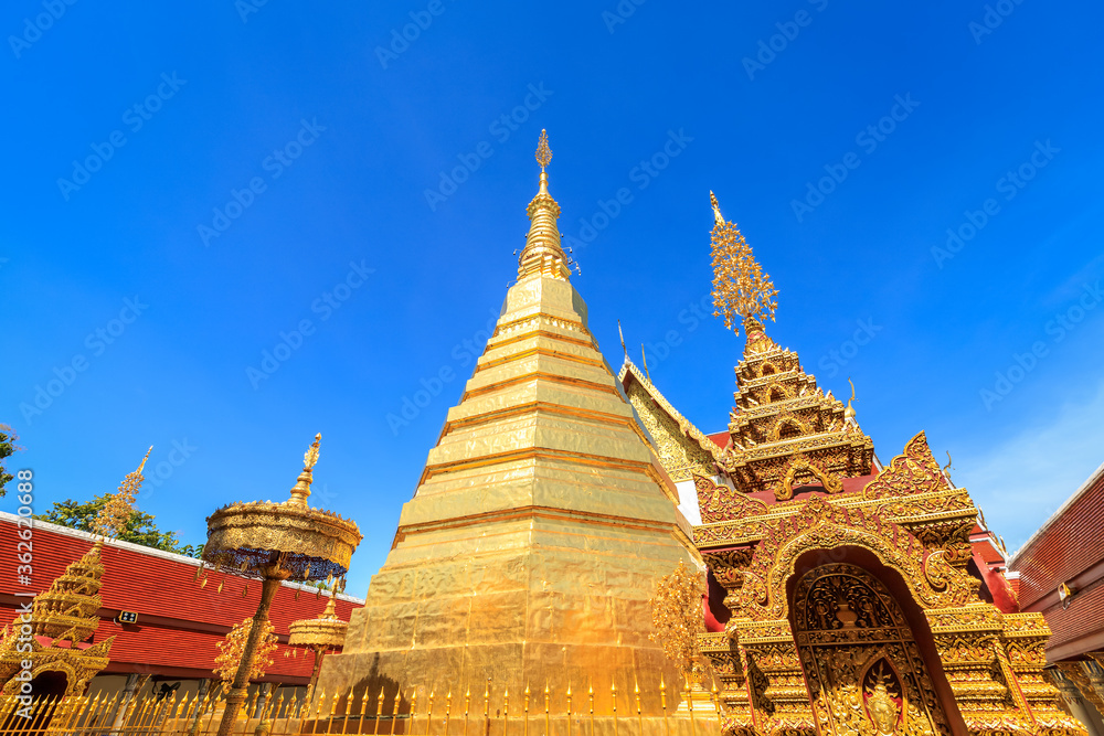 Fototapeta premium Golden pagoda for year of tiger zodiac at Wat Prathat Cho Hae Temple in Phrae province, north of Thailand