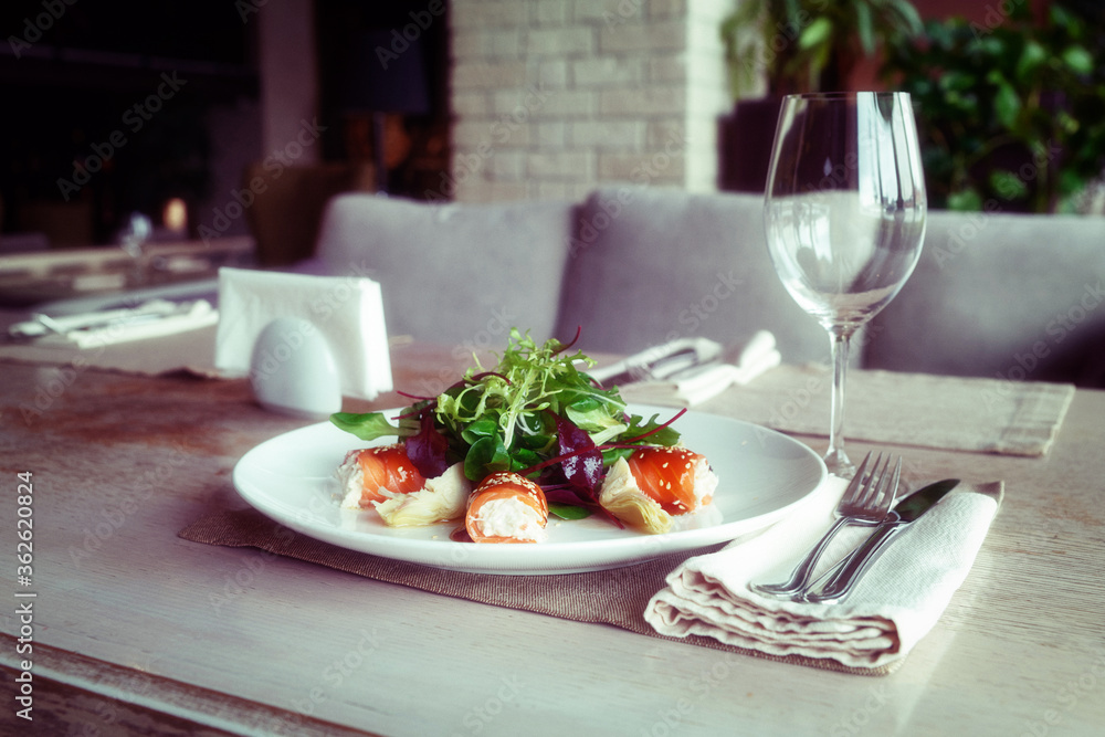 Fotografie Salmon roll with crab meat stuffing on table, toned