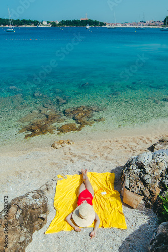 woman sunbathing at sea beach in sunny day