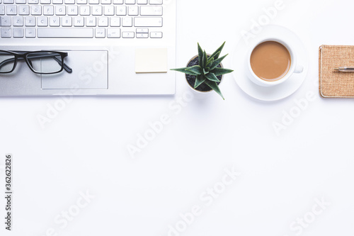 Flat lay, Workplace with laptop, coffe and office supplies on withe desk. With copy space.