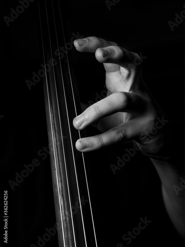 Black and white photograph of a young cellist playing classical music