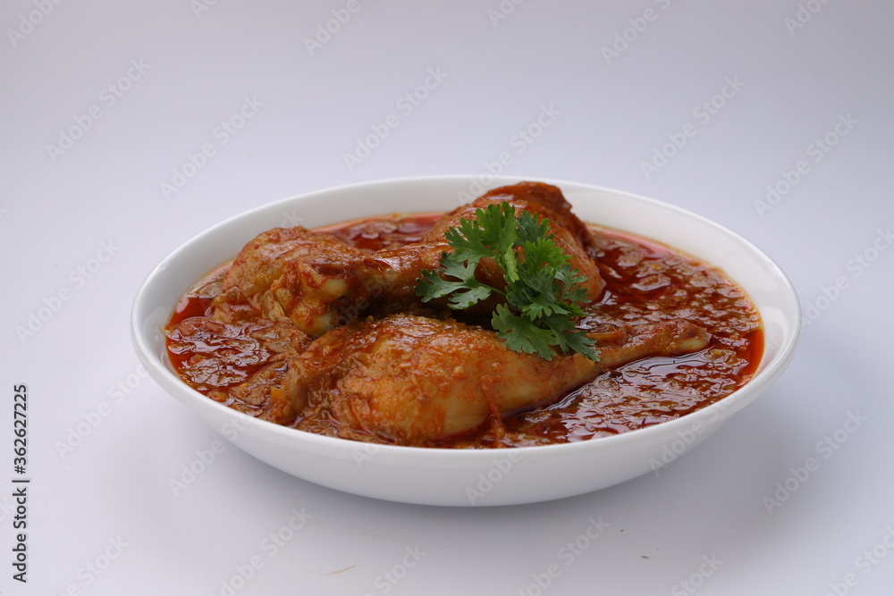 Chicken curry or masala,arranged in awhite bowl with white background