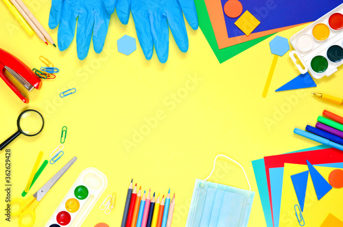 Back to school. school supplies on a yellow background. The concept of learning during the coronavirus pandemic. flat lay. copy space.