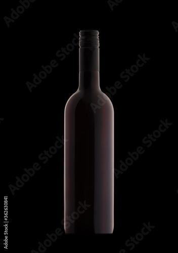 A bottle of red wine on a black background close-up.