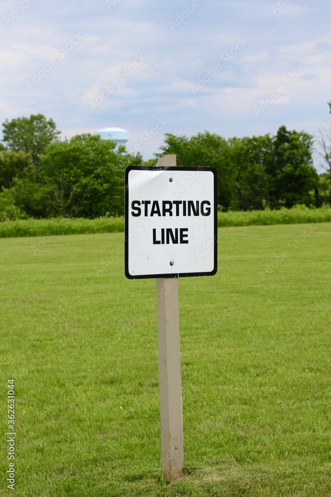 A close view of the black and white starting line sign. A close view of the black and white starting line sign.