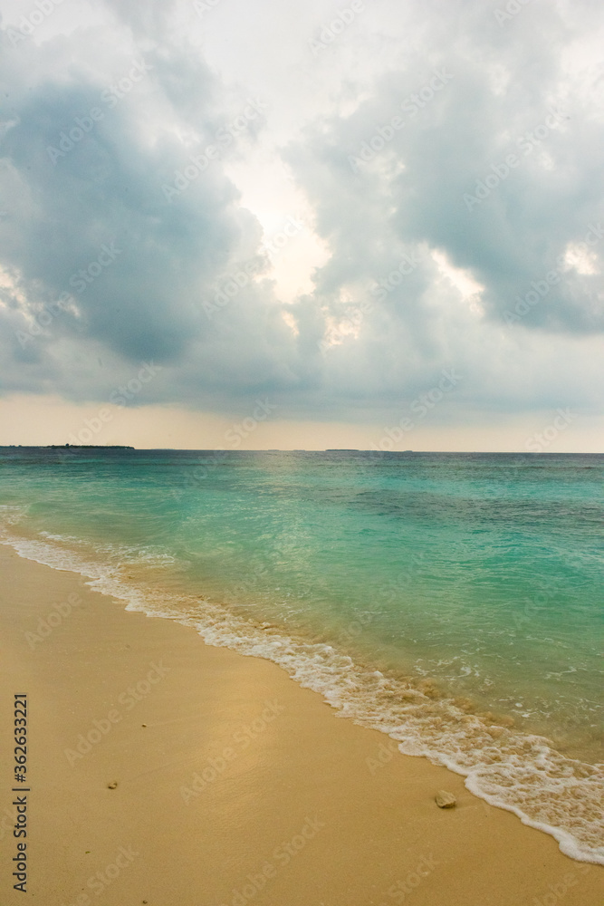 Cloudy skies on a beach in Dharavandhoo Maldives
