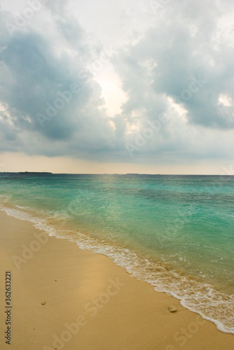 Cloudy skies on a beach in Dharavandhoo Maldives