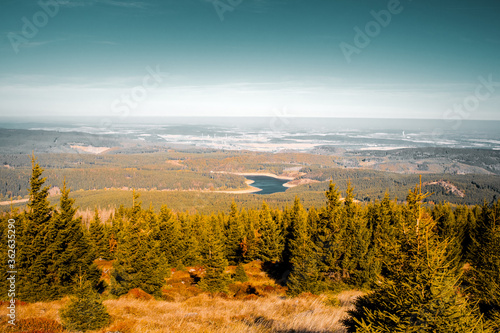 View from the brocken to the landscape nature with mountain lake on bright sunny day. Perfect mountain hiking adventure. Brocken, Harz Mountains, Harz National Park in Germany. photo