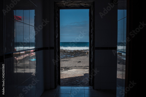View from a window of a beach.