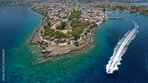 Aerial drone photo of picturesque fishing village of Perdika next to iconic small island of Moni, Aigina island, Saronic gulf, Greece