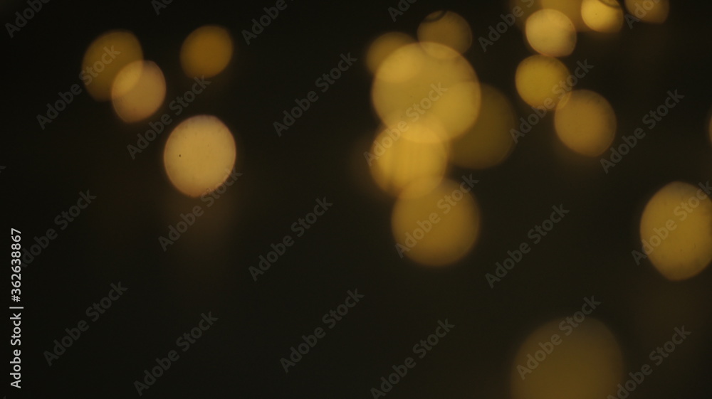 Obraz premium Natural Gold Color Bokeh Particles Effect Photo Overlays Background Glowing Abstract Lens Lights Defocused Circles and Blur Golden Glitter Beautiful Glamour Style. Use Screen Overlay Mode.