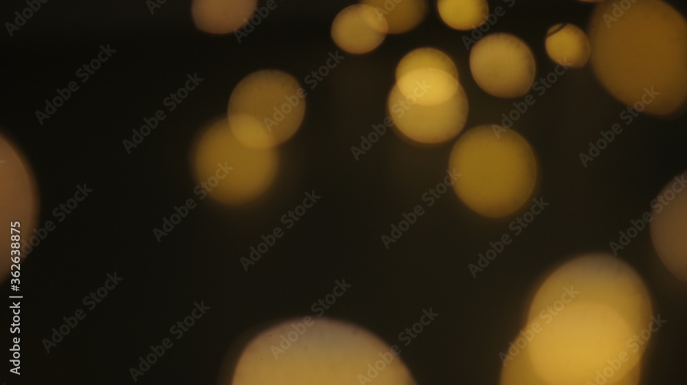 Obraz premium Natural Gold Color Bokeh Particles Effect Photo Overlays Background Glowing Abstract Lens Lights Defocused Circles and Blur Golden Glitter Beautiful Glamour Style. Use Screen Overlay Mode.
