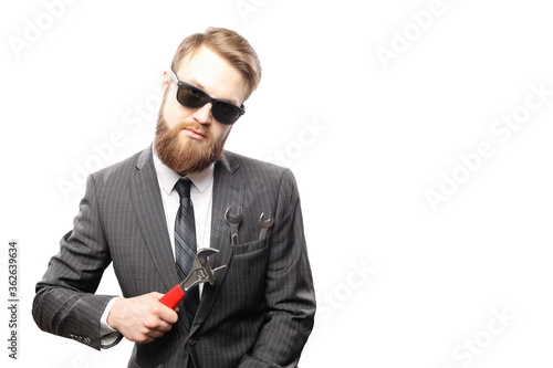 Bearded man in suit and wrench inside pocket isolated on white background