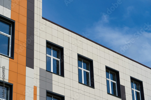 facade of a modern building on a bright Sunny day  siding and Windows  beautiful exterior of the new building