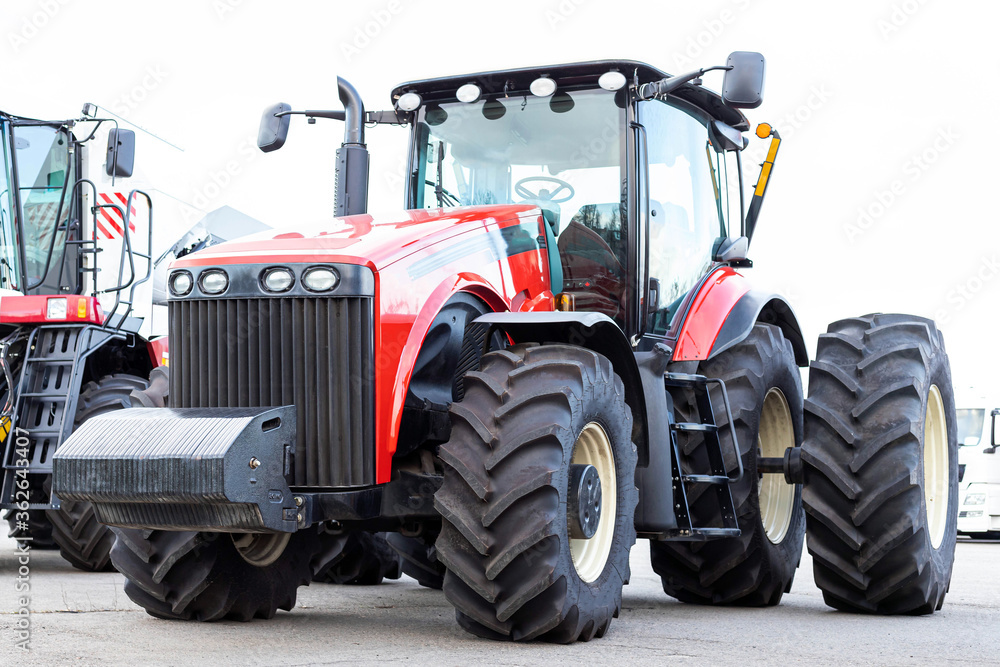 Large agricultural tractor on a white background. Equipment for cultivating the land. Side view. Close-up. Large agricultural tractor on a white background. Equipment for cultivating the land. Side view. Close-up.