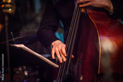 Double-bass fragment in jazz concert stage in musican hands