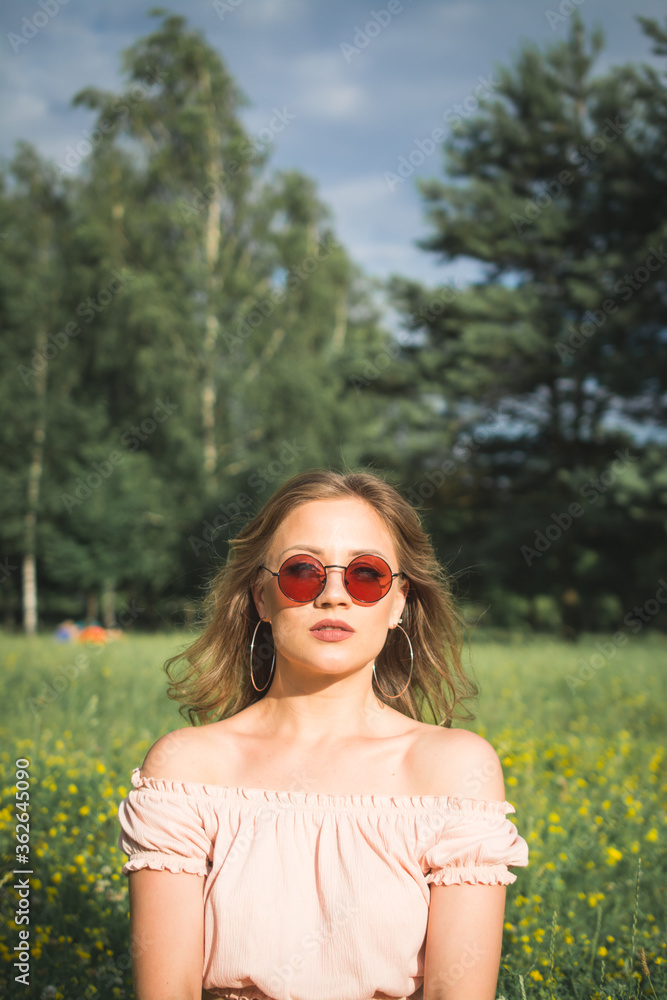 Stylish and fashionable portrait of a beautiful girl in the summer park Stylish and fashionable portrait of a beautiful girl in the summer park
