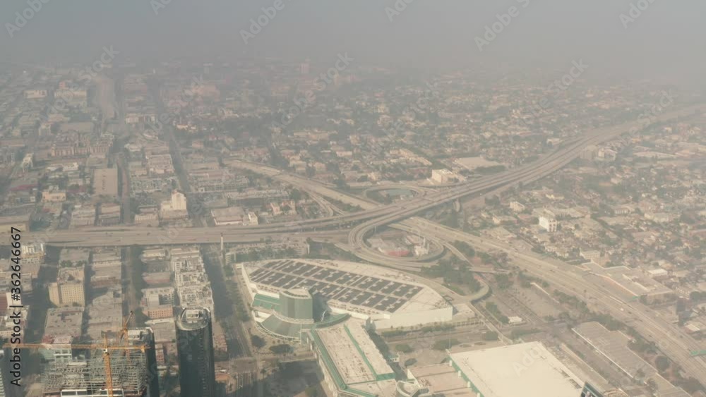 Hazy apocalyptic aerial of Downtown Los Angeles, skyscrapers in smog, low visibility Hazy apocalyptic aerial of Downtown Los Angeles, skyscrapers in smog, low visibility