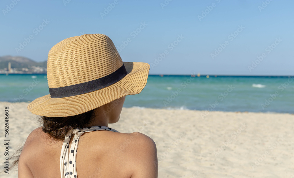 Vacation. Travel. Beautiful young woman relaxing on beach