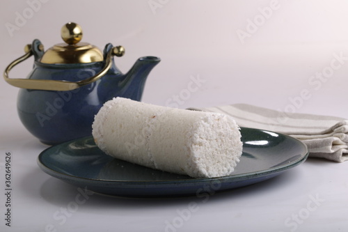 PUTTU or WHITE RICE PITTU ,Kerala special breakfast items made using rice flour which is very healthy and arranged in traditional way with  blue background photo