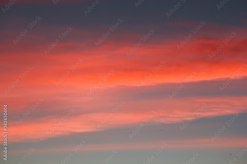 A strip of red clouds at sunset.