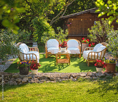 Εκτύπωση καμβά Cozy garden lounge chairs with pillows, surrounded by flowers