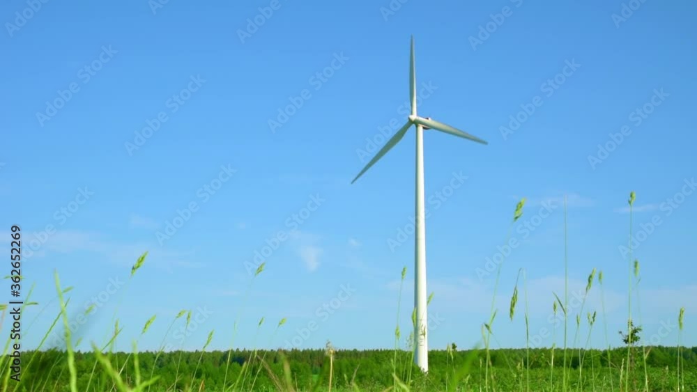 Wind turbine in field. Wind power energy concept. Renewable energy for climate protection Wind turbine in field. Wind power energy concept. Renewable energy for climate protection