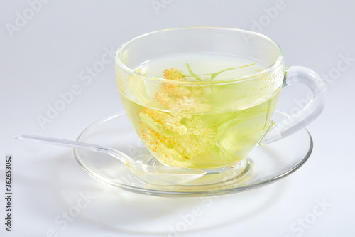 Transparent glass cup of tea with linden isolated on white