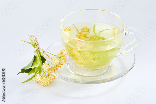 Transparent glass cup of tea with linden isolated on white
