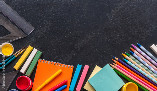 Back to school concept. Stationery on the black background