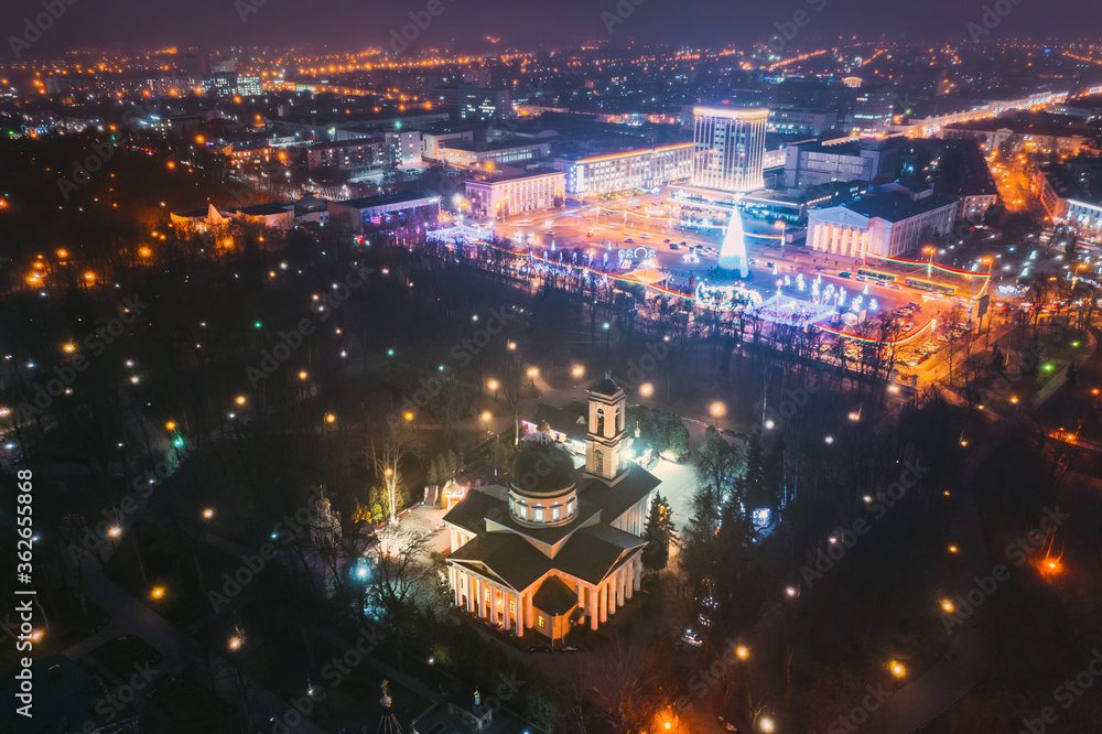 Gomel, Belarus. Main Christmas Tree And Festive Illumination On Square In Homel. New Year In Belarus. Aerial Night View. Peter And Paul Cathedral In Rumyantsevs And Paskeviches Park. Local Landmark Gomel, Belarus. Main Christmas Tree And Festive Illumination On Square In Homel. New Year In Belarus. Aerial Night View. Peter And Paul Cathedral In Rumyantsevs And Paskeviches Park. Local Landmark