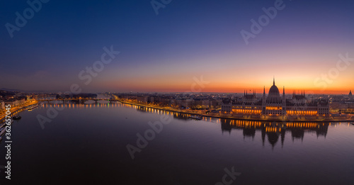 Panoramic aerial drone shot of Hungarian Parliament lights off sunrise in Budapest dawn