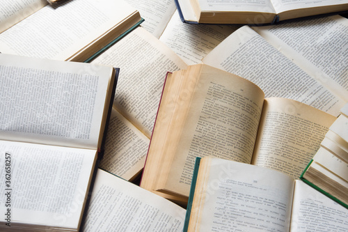 A pile of books lies on the floor
