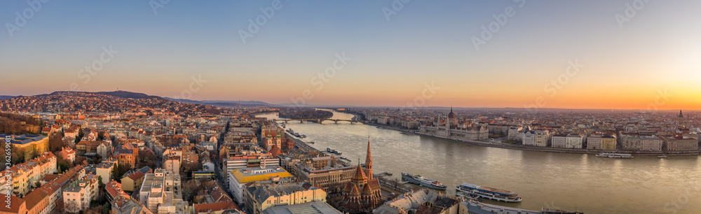 Naklejka premium Panoramic aerial drone shot of Budapest skyline sunrise over Danube river with Hungarian Parliament