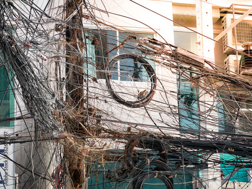 messy chaos wires cables , telephone and internet fiber signal line on electric poles.