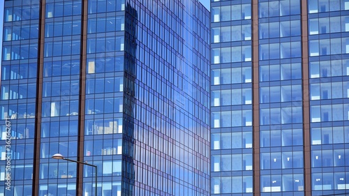 Facade texture of a glass mirrored office building. Fragment of the facade. Modern architecture of the office building.