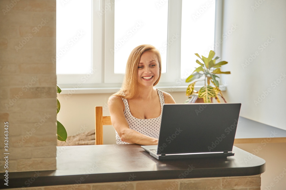 Funny girl professional laughter sitting with a laptop on a home office Desk, positive European woman fun to enjoy sincere emotions laughter study work on a PC. Quarantine, remote work. Funny girl professional laughter sitting with a laptop on a home office Desk, positive European woman fun to enjoy sincere emotions laughter study work on a PC. Quarantine, remote work.
