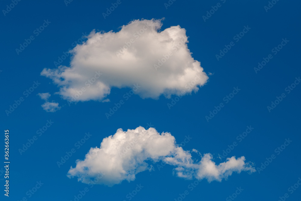 Two clouds. Clouds on the blue sky. Natural sky background. Two clouds. Clouds on the blue sky. Natural sky background.