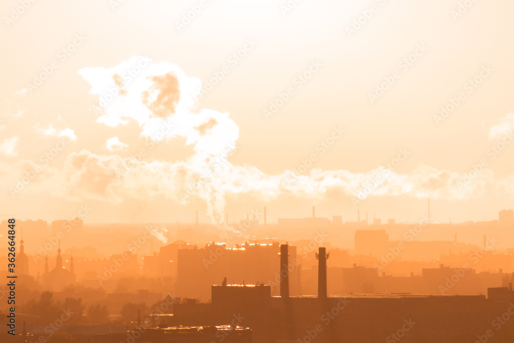 Beautiful orange sunset over the city of Ryazan in summer. Far away smoke from the factory in the rays of sunset